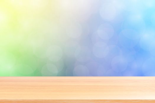 empty wood table floors on blurred bokeh soft blue gradient background, wooden plank empty on blue bokeh colorful light shade, colorful bokeh lights gradient soft for banner advertising products