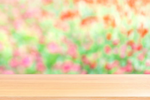 wood plank on blurred flower pink and green soft background, empty wood table floors on blurred flower pink soft garden nature background, wood table board empty for mock up display products