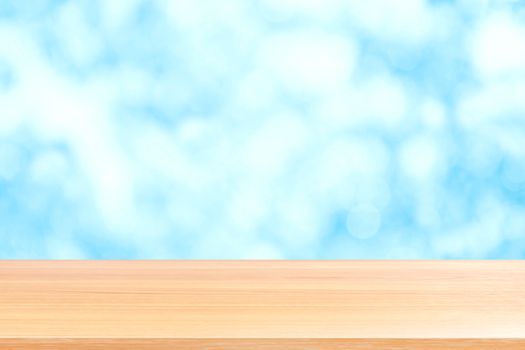 wood plank on blurred blue bokeh sky soft texture background, empty wood table floors on soft bokeh blue soft colorful light, wood table board empty on blue soft texture background