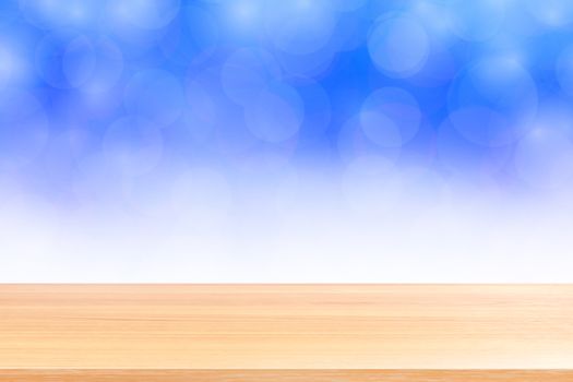 empty wood table floors on blurred bokeh soft blue white gradient background, wooden plank empty on blue bokeh colorful light shade, colorful bokeh lights gradient soft for banner advertising products