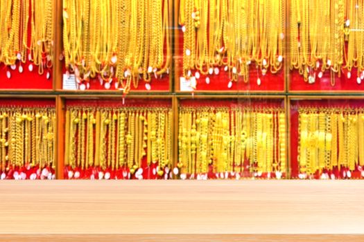 wood plank on blurred gold background blurred, empty wood table floors on panel gold shop jewelry store for seller recommend products and gold showcase, wood table board empty front gold shop wall