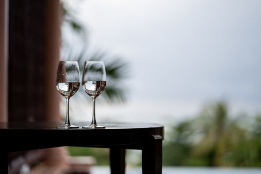 Glass of water on balcony, Tropical view.