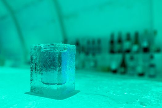 Cocktail short glass made of ice. In Igloo ice bar in winter season.