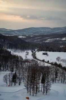 Winter snow mountain forest with road landscape.