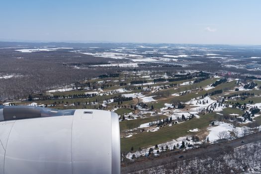 View of beautiful city covered by snow from a airplane window.