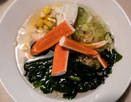 Delicious Japanese ramen noodles with Crab, and seaweed on bowl.