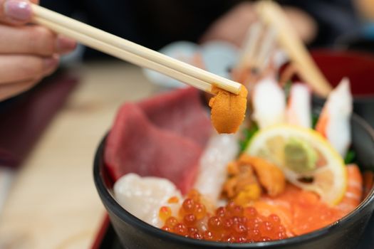 Kaisen Don (Sashimi seafood Rice Bowl) served in a black Bowl, Japanese food.