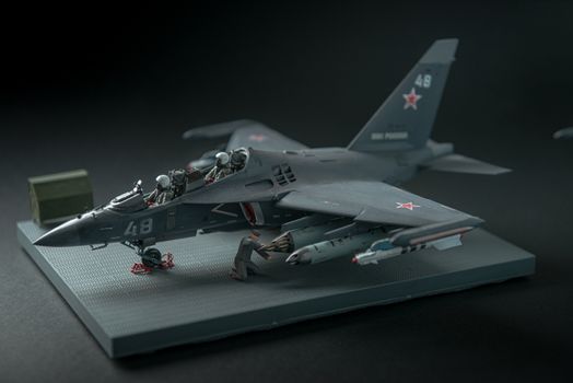 military fighter on a black background with place for text. On the tail of the plane is a red star of the Soviet army