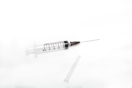 medical syringe with needle on an isolated white background with place for text