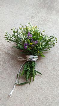 Festive wild flowers composition on the grey background. Overhead view.