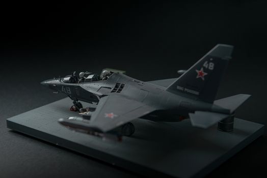 military fighter on a black background with place for text. On the tail of the plane is a red star of the Soviet army