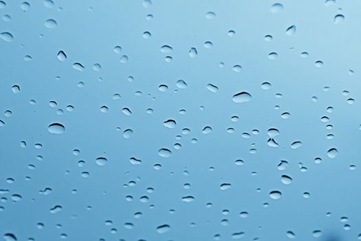 water rain drop on soft blue nature glass for abstract fresh background