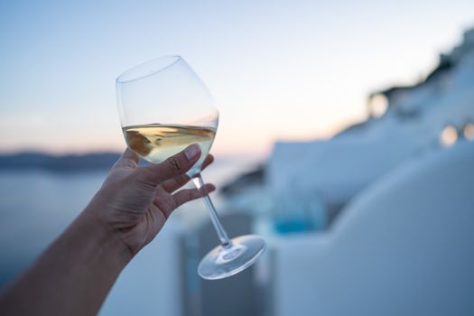 A glass of wine in hand.