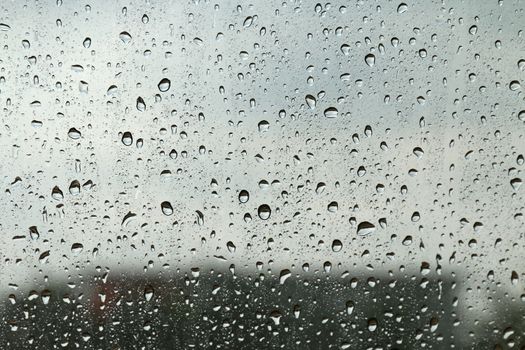 Water drop fresh condensation on window glass texture, rainy season wet background cooling feels and cold, raindrops texture wet transparent bubble