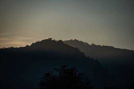 Mountain landscape with flare of the sun rise.