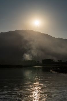 Mountain landscape with flare of the sun rise.