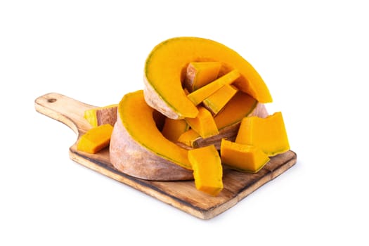 Slice of pumpkin on wooden board isolated on a white background.