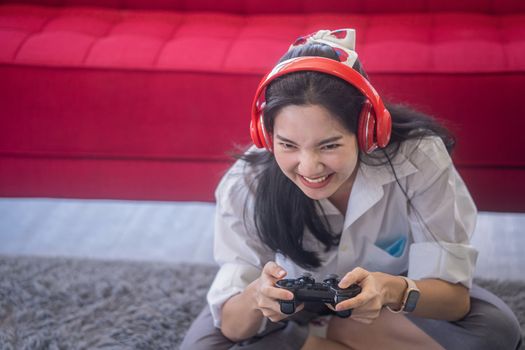 young asian woman enjoy her media gaming in the living room