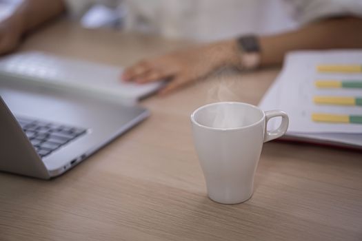 hot coffee cup on computer table