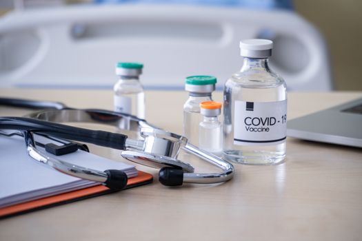 The covid19 doz on the table with blur doctors background. Novel Covid19 vaccine Concept.