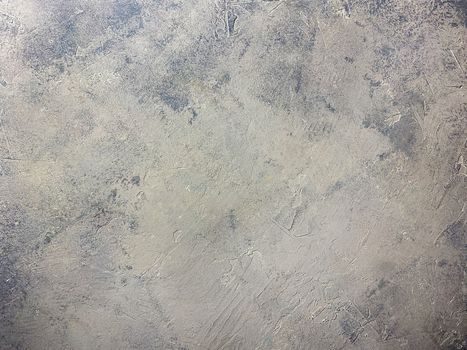 Concrete beige gray background with scuffs and gray splashes. Textured wall texture in the grunge style.