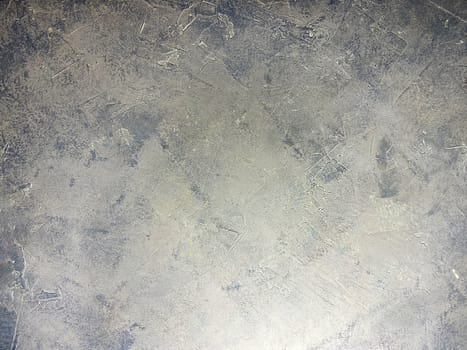 Concrete beige gray background with scuffs and gray splashes. Textured wall texture in the grunge style.