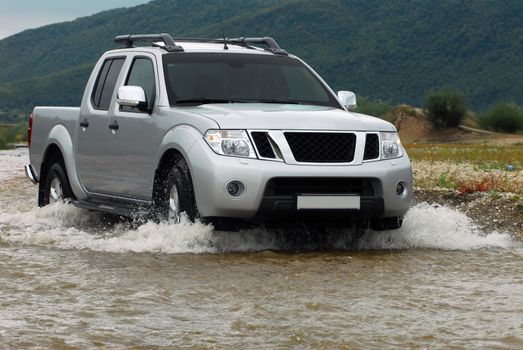 Suv splash on the river outdoor, traveling on the road