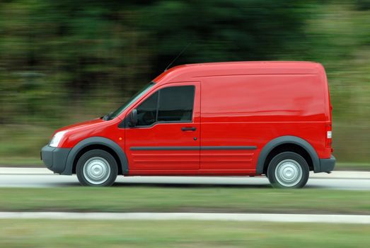Panning image red delivery car