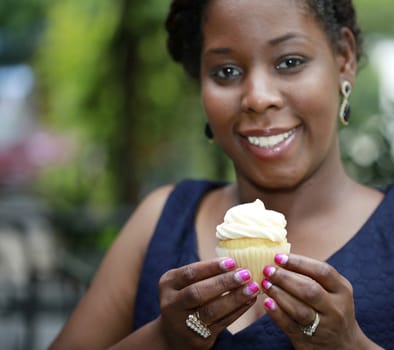 Close up of African American women's hands holding cupcake