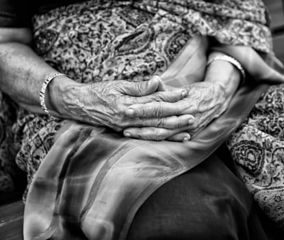 Wrinkled hands of Indian woman, dressed in traditional sari
