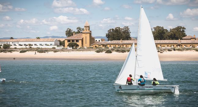 Tavira Island, Portugal - May 3, 2018: People dressed as sailor taking a boat lesson on the Ria Formosa lagoon on a spring day