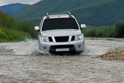 Suv splash on the river outdoor, traveling on the road