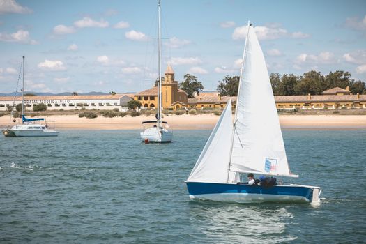 Tavira Island, Portugal - May 3, 2018: People dressed as sailor taking a boat lesson on the Ria Formosa lagoon on a spring day