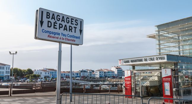 port joinville on the island of Yeu, France - September 18, 2018: Luggage panel Departure Compagnie Yeu Continent in French in front of the ferry terminal of the island of Yeu