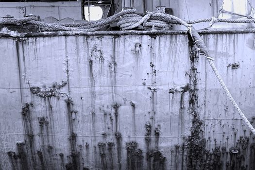 Monochrome image of old ship hull and ropes
