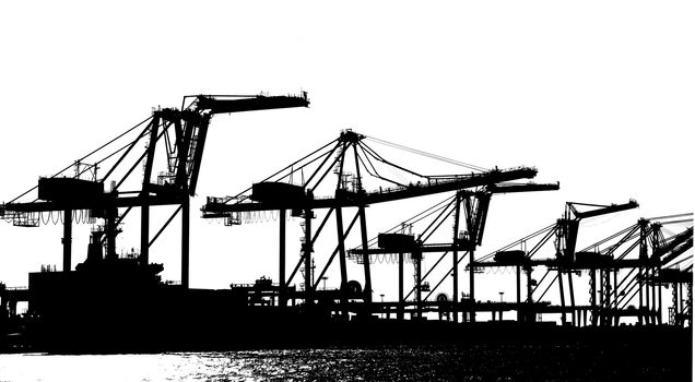 Silhouette of large cranes used for loading containers on to ships