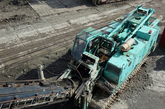 Large construction equipment item with tank treads
