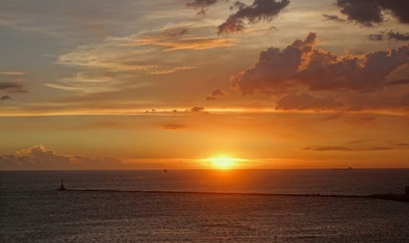 The sun is setting on a nice summer day at Kaohsiung Harbor