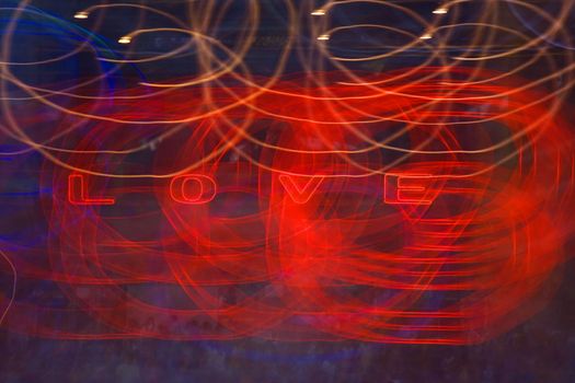 Light painting with the illuminated word LOVE and blurs