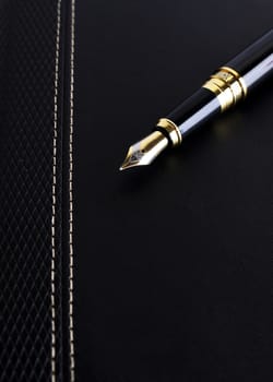 Close up of Fountain pen on leather cover book for Business concept