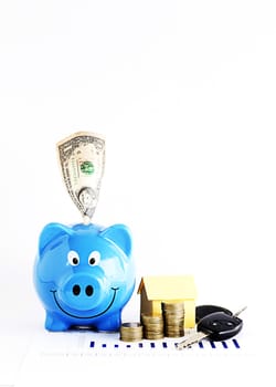 Piggy bank with dollar and coins stack and home paper and carkeys for Loans money concept Vertical