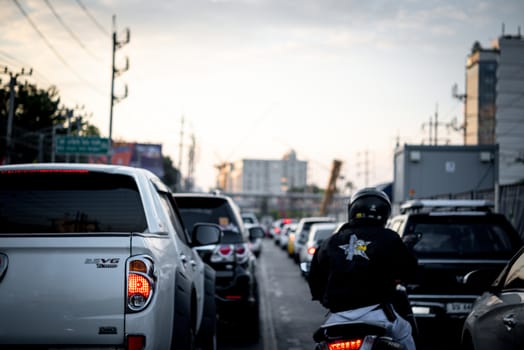 Bangkok, Thailand - November 22, 2019 : Cars on busy road in the Bangkok city, Thailand. Many cars use the street for transportation in rushhour with a traffic jam