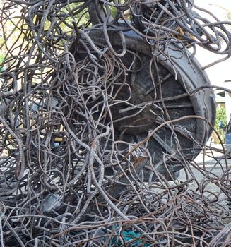 A powerful industrial magnet picks up scrap metal from a demolition project