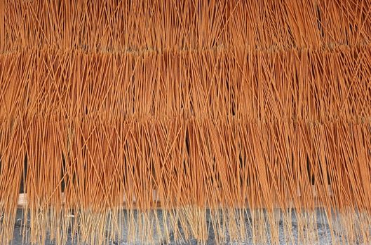 A store for religious artifacts dries incense sticks in the sun