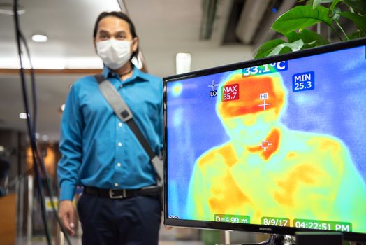 Bangkok, Thailand - March 18, 2020 : Unidentified people waiting body temperature check to access building for against epidemic flu covid19 or corona virus by thermoscan or infrared thermal camera