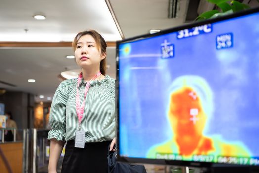 Bangkok, Thailand - March 18, 2020 : Unidentified people waiting body temperature check to access building for against epidemic flu covid19 or corona virus by thermoscan or infrared thermal camera