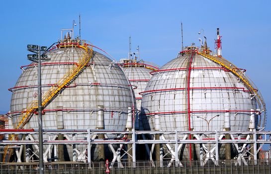 Large spherical fuel storage tanks with fuel pipes and ladders
