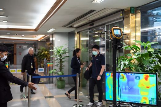 Bangkok, Thailand - March 17, 2020 : Unidentified people waiting body temperature check to access building for against epidemic flu covid19 or corona virus by thermoscan or infrared thermal camera