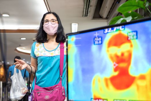 Bangkok, Thailand - March 18, 2020 : Unidentified people waiting body temperature check to access building for against epidemic flu covid19 or corona virus by thermoscan or infrared thermal camera