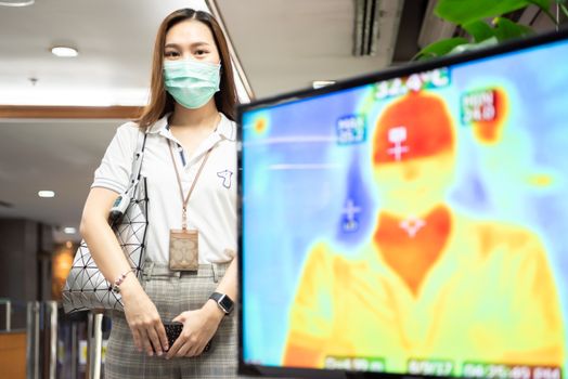 Bangkok, Thailand - March 18, 2020 : Unidentified people waiting body temperature check to access building for against epidemic flu covid19 or corona virus by thermoscan or infrared thermal camera